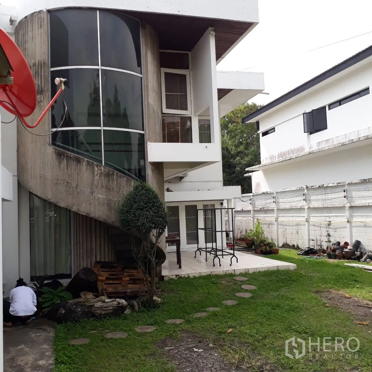 Detached House for rent in Khlong Toei, Bangkok - Modern white detached house with a curved glass stairwell and patio opening to a green lawn in Phra Khanong.
