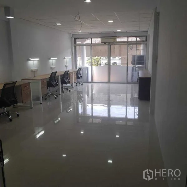 Home Office for rent or sale in Suan Luang, Bangkok - Long, bright office zone with multiple workstations and sliding balcony doors.