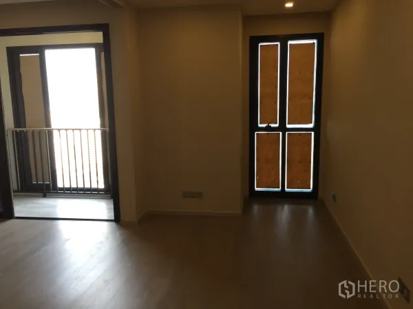 Condominium for sale in Watthana, Bangkok - Bright bedroom with access to a small balcony and full-height windows.
