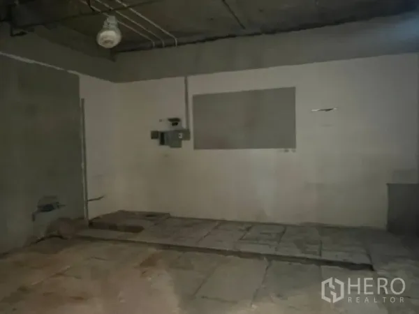 Retail Space for rent in Watthana, Bangkok - Bare-shell retail interior with concrete floor, exposed ceiling, and utility panels ready for fit-out.
