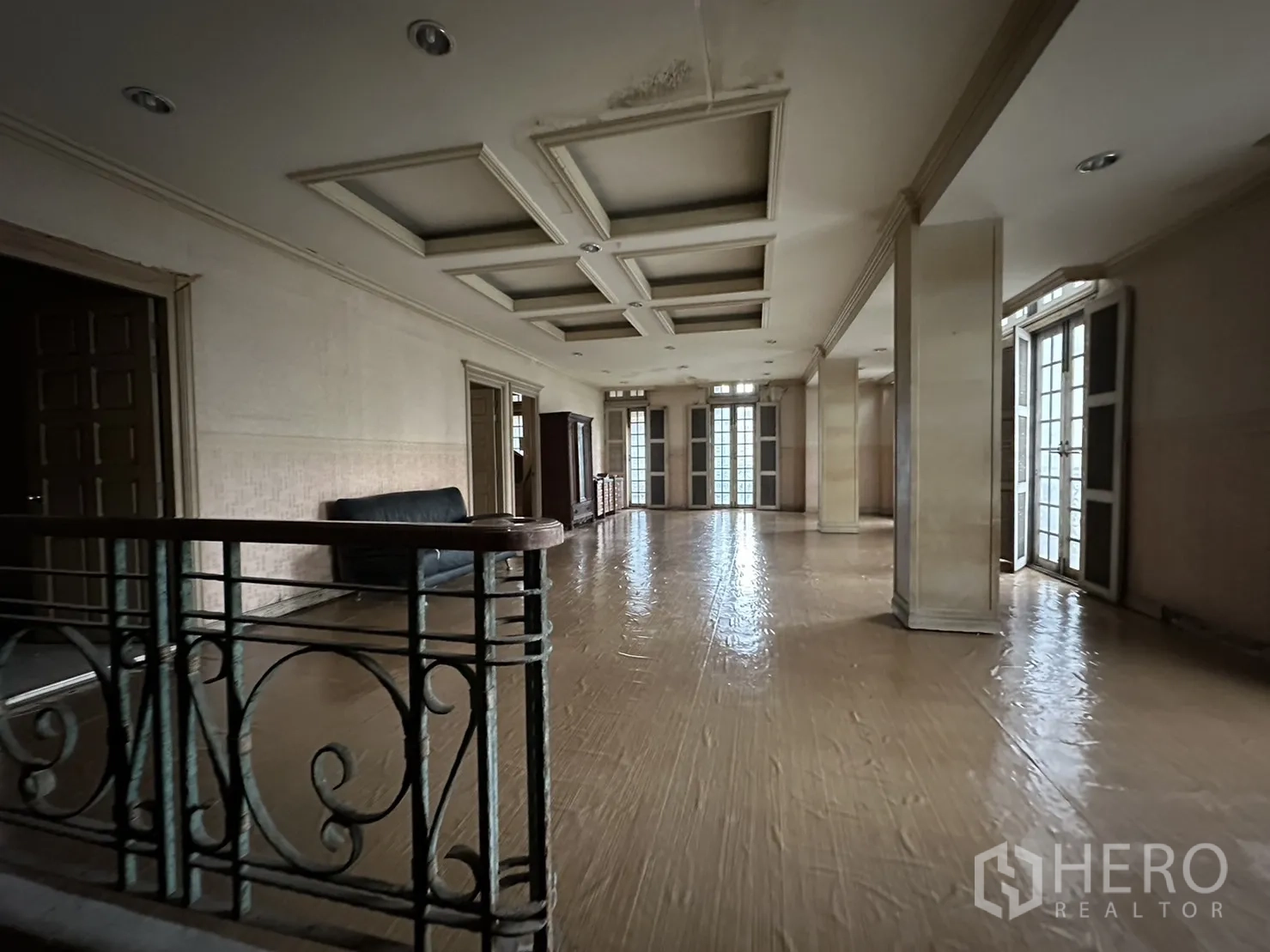 Home Office for rent in Huai Khwang, Bangkok - Open upper-floor hall with coffered ceiling, wood floors and multiple doors.
