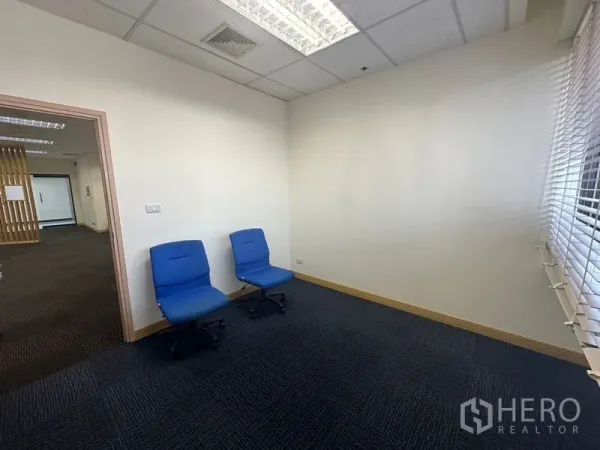 Office Space for rent in Bang Na, Bangkok - Small private office with two blue chairs, carpet flooring and window blinds.