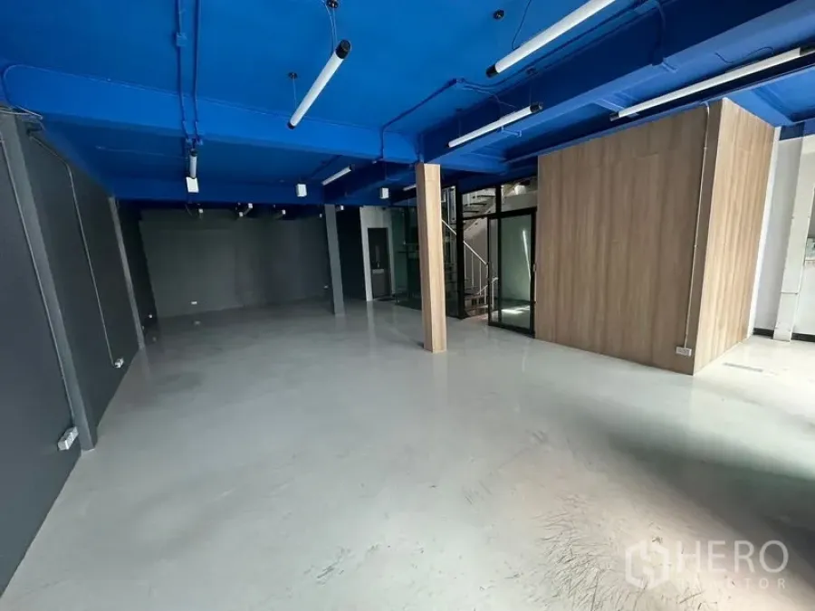 Office Space for rent in Watthana, Bangkok - Spacious 90 sqm office featuring LED strip lights, support columns and a versatile open layout.
