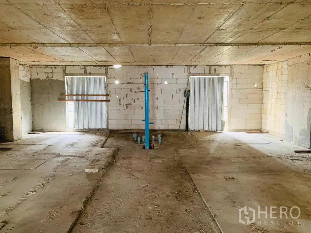 Home Office for rent - Large unfinished floor plate with service riser and shuttered window openings.