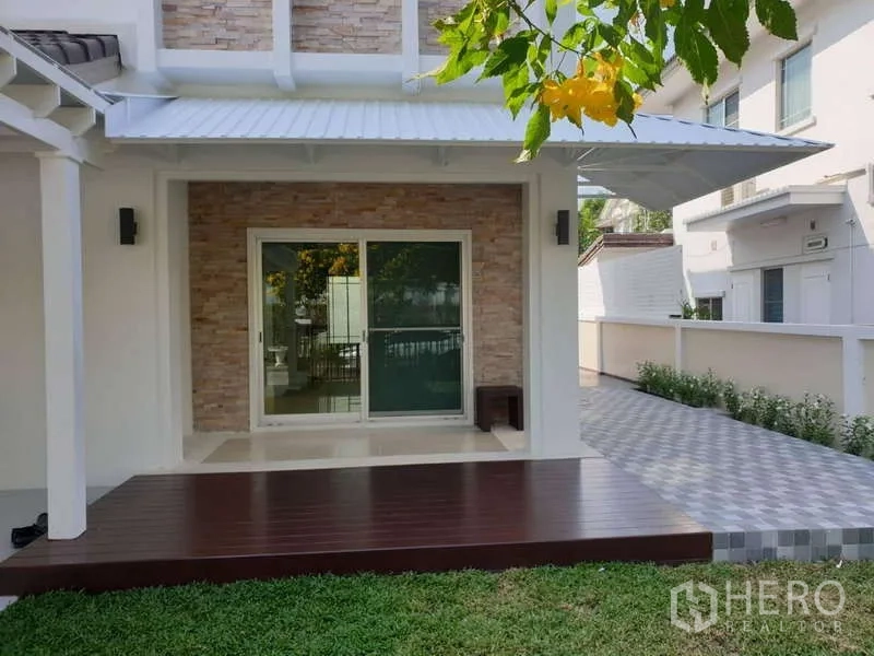 Detached House for rent in Sathon, Bangkok - Covered terrace with sliding glass door, raised wood deck, and side walkway.
