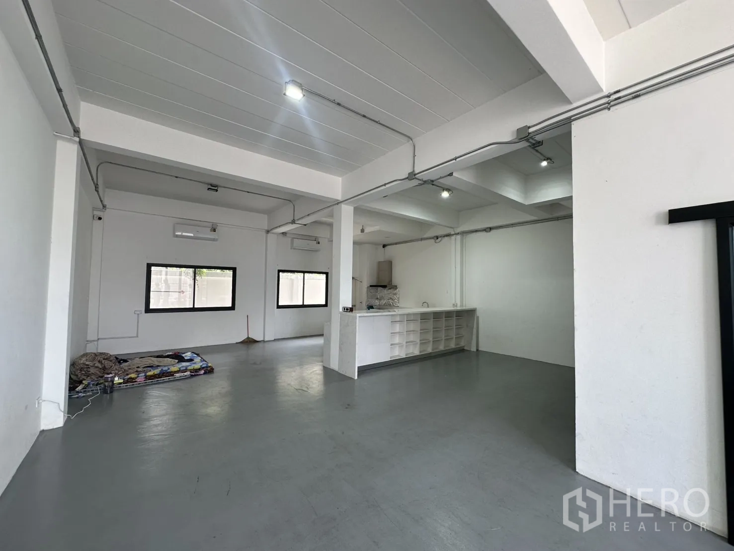 Home Office for rent or sale in Bang Na, Bangkok - Spacious work zone with exposed conduits, windows and a built-in counter.