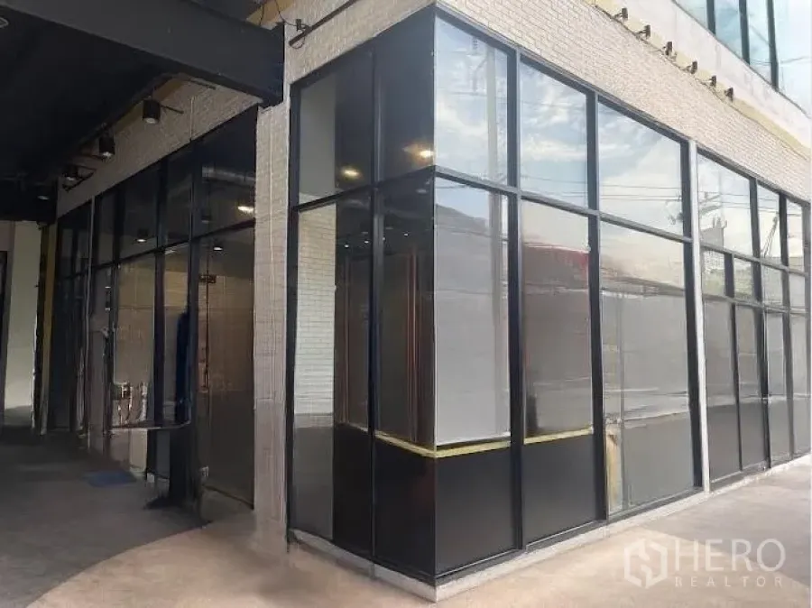 Retail Space for rent - Glass corner shop facade offering two street-facing frontages in a contemporary complex.