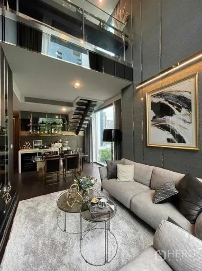 Condominium for rent or sale - Open-plan living and dining with double-height ceiling and mezzanine walkway.