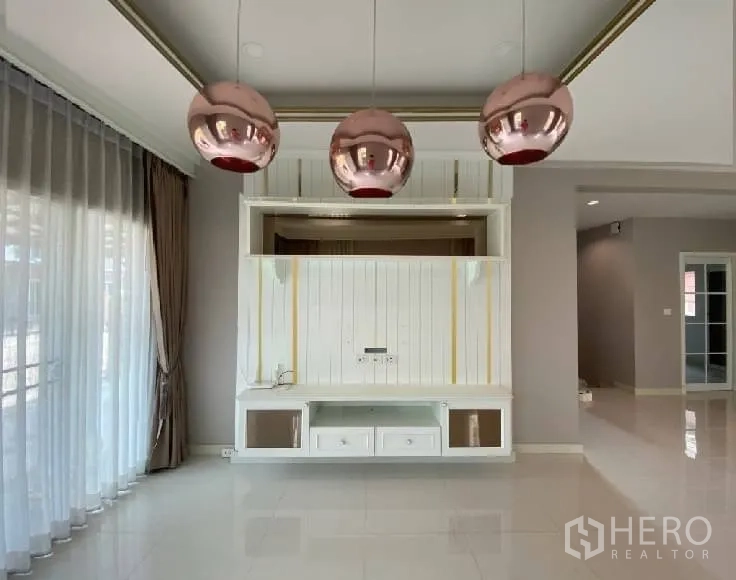 Detached House for rent in Suan Luang, Bangkok - Close-up of white built-in media wall with three copper pendant lamps.
