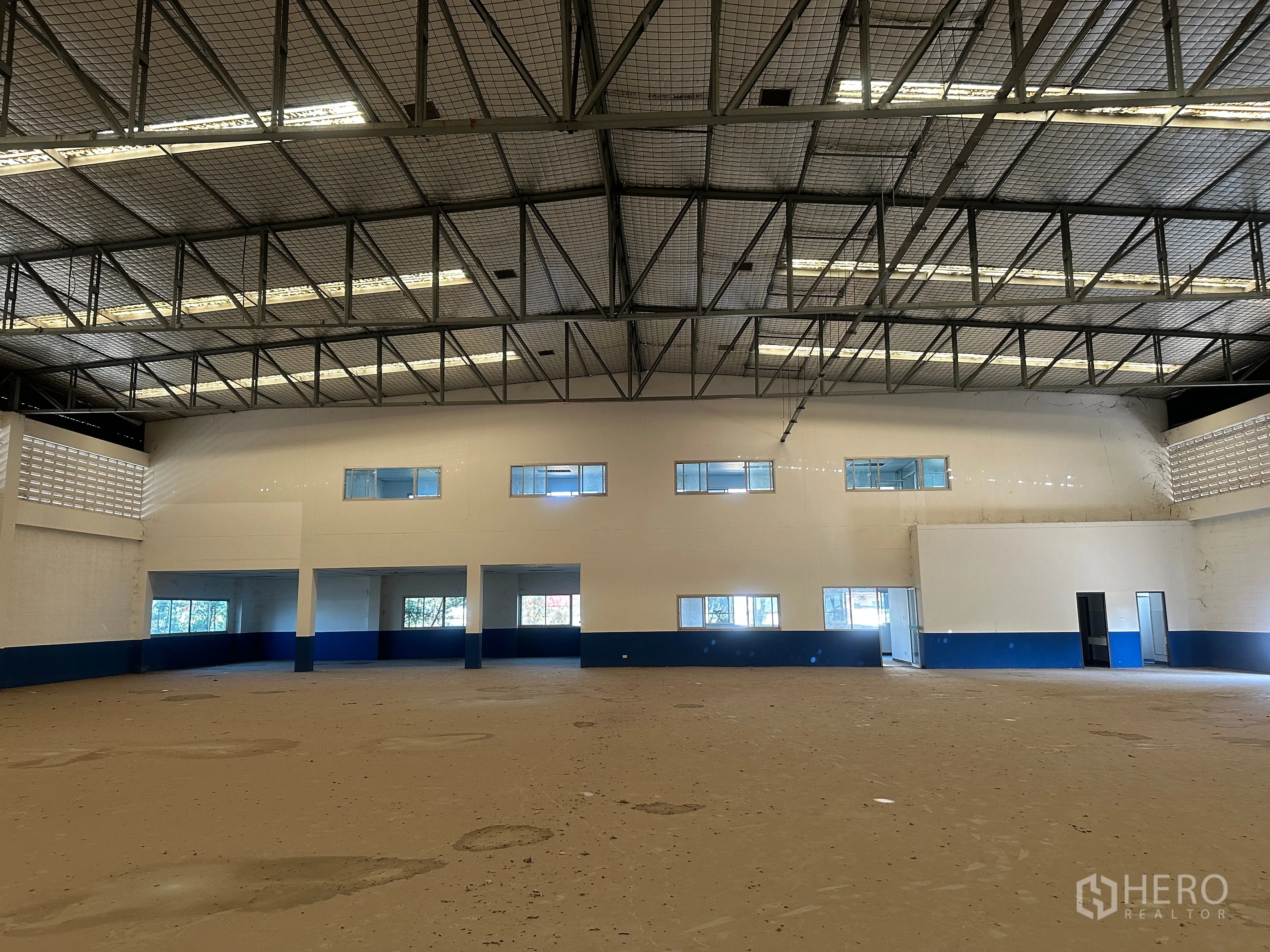 Factory for rent in Bang Pa-in, Phra Nakhon Si Ayutthaya - Warehouse view toward mezzanine offices with multiple windows above work bays.