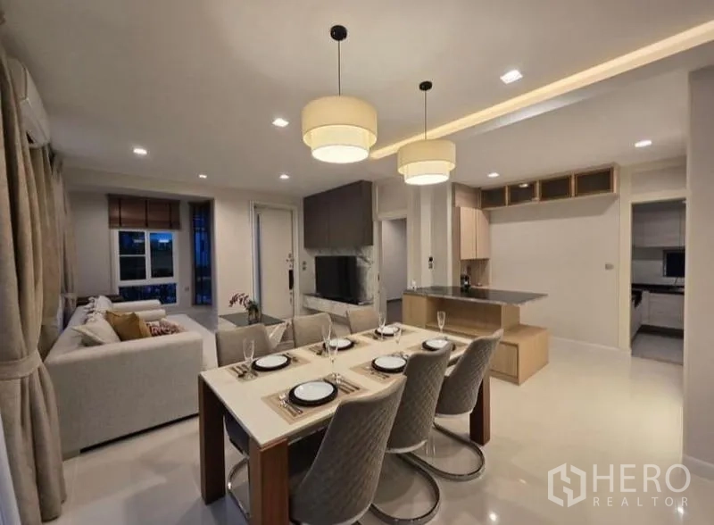 Detached House for rent - Dining zone with six-seat table beside kitchen island and warm pendant lights.