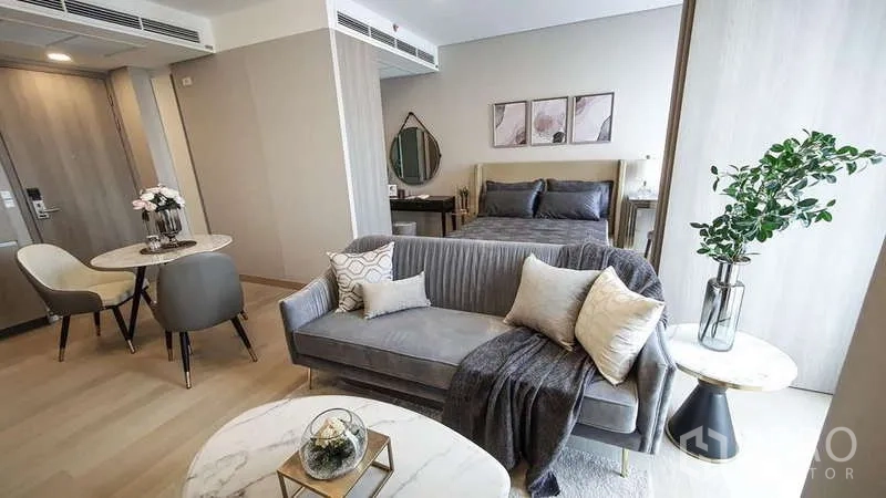 Detached House for rent in Bang Phli, Samut Prakan - Compact guest suite with sofa, dining nook and bed in a neutral palette with wood flooring.