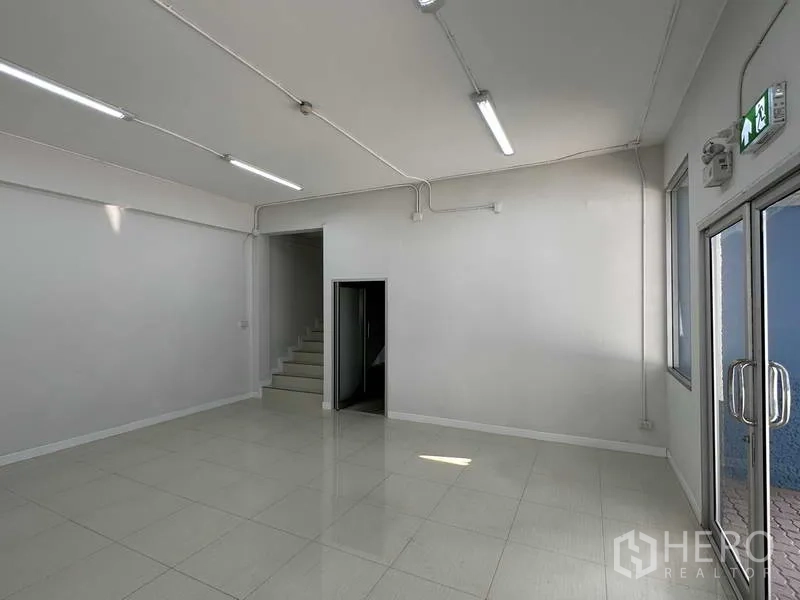 Factory for rent in Bang Phli, Samut Prakan - Ground-floor reception or office room with stair access and double glass doors.