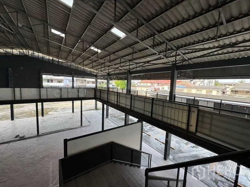 Warehouse for rent in Phra Khanong, Bangkok - View from the mezzanine walkway showing high ceilings, skylights and an open warehouse floor.