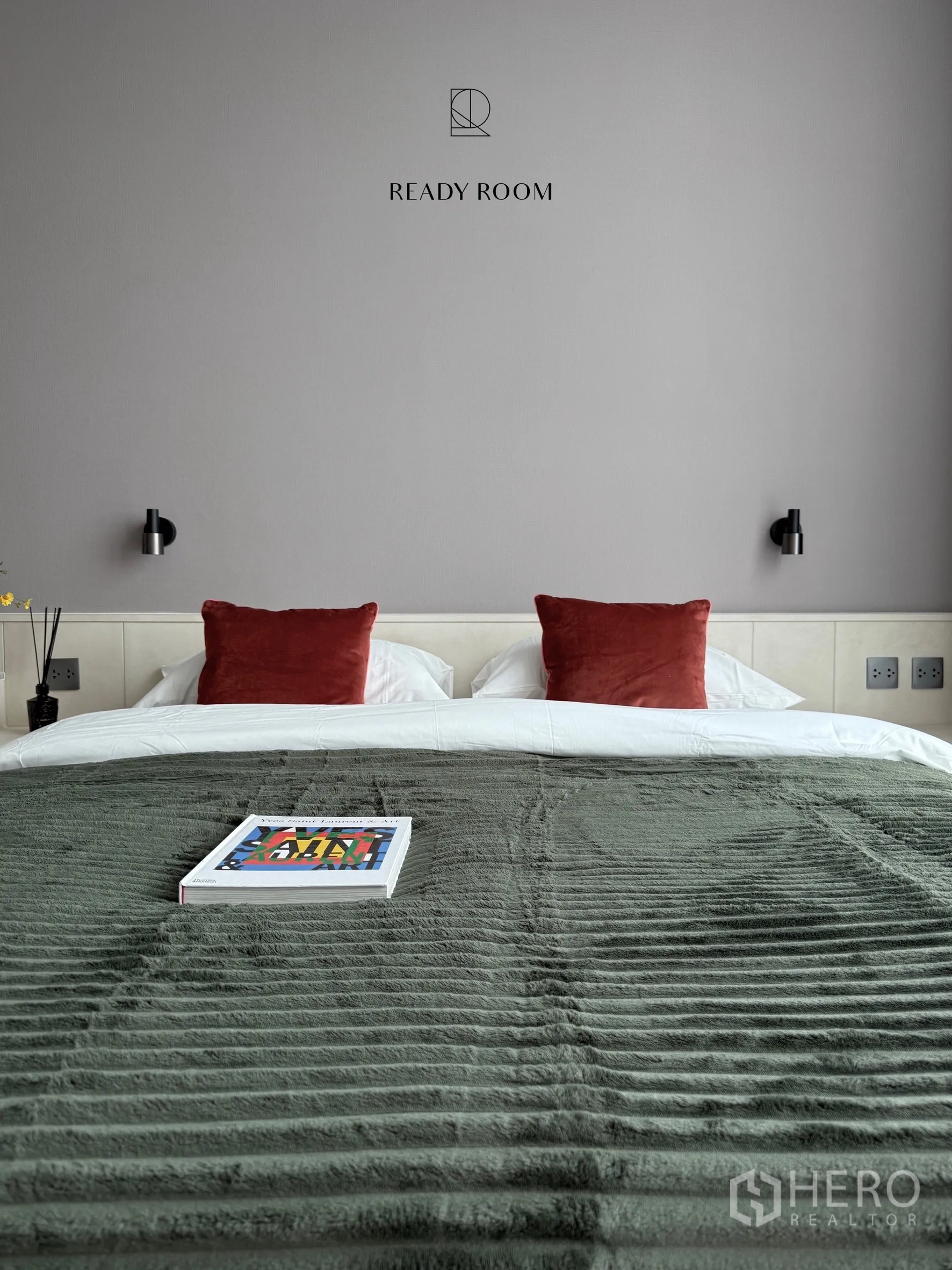 Condominium for rent in Khlong Toei, Bangkok - Bedroom with double bed, green throw, and red cushions.