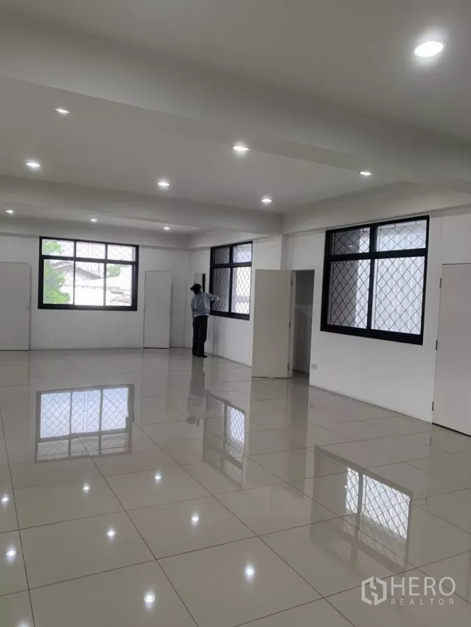 Factory for rent in Mueang Samut Prakan, Samut Prakan - Bright tiled office room with large windows and recessed lighting.