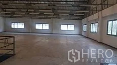 Factory for sale in Lam Luk Ka, Pathum Thani - Open production floor with high ceiling, concrete slab and rows of windows for natural light.