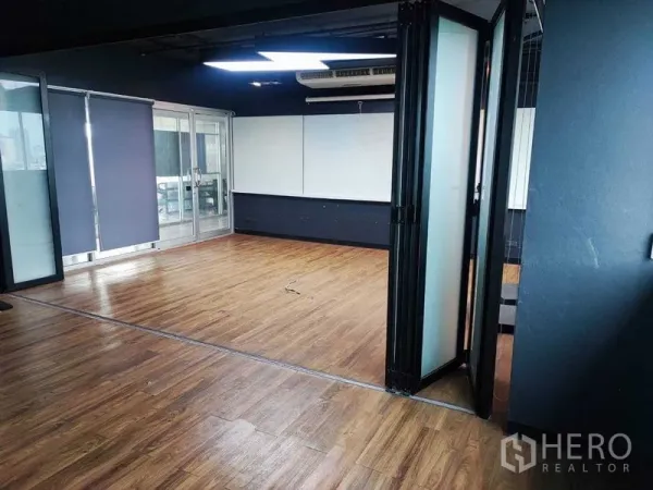 Office Space for rent in Watthana, Bangkok - Flexible workspace with sliding glass doors, blackout blinds, and a whiteboard feature wall.