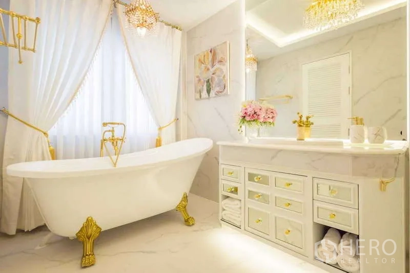 Townhouse for rent in Lat Phrao, Bangkok - Luxury bathroom with freestanding clawfoot tub, gold fittings and marble finishes.