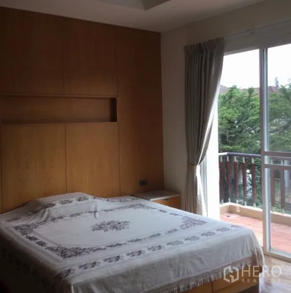 Detached House for rent in Bang Phli, Samut Prakan - Master bedroom opening to a private balcony with sliding glass doors and curtains.