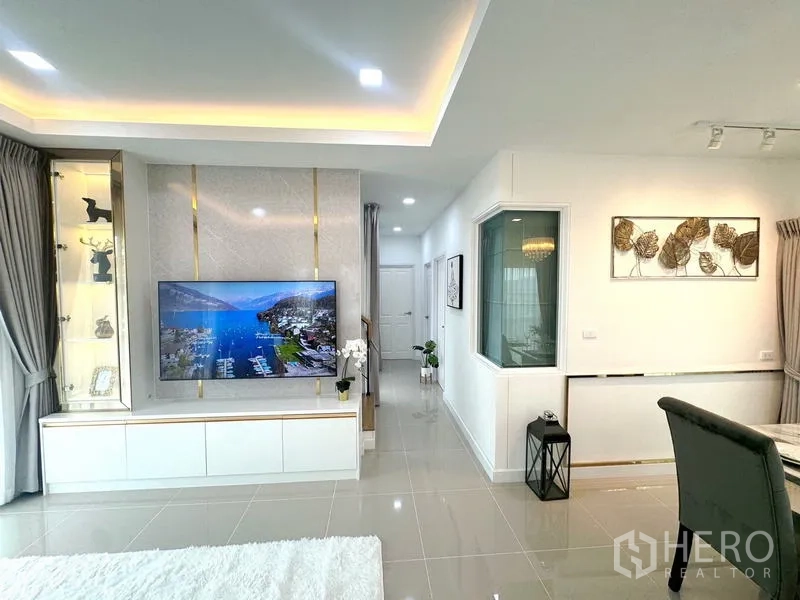 Detached House for rent - Living room TV feature wall with built-in cabinet leading to hallway.