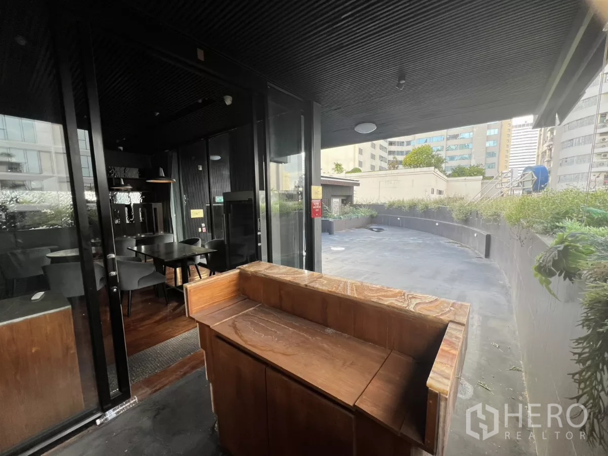 Retail Space for rent - Entry from the terrace to the dining room with a wood hostess counter.