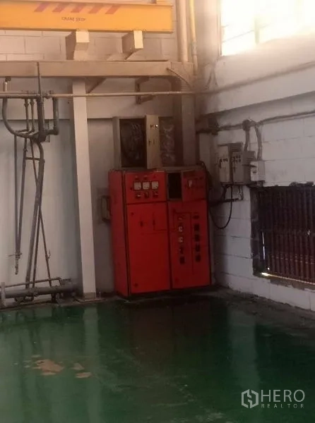 Factory for sale in Khlong Luang, Pathum Thani - Industrial electrical control panel and utility piping inside the factory.
