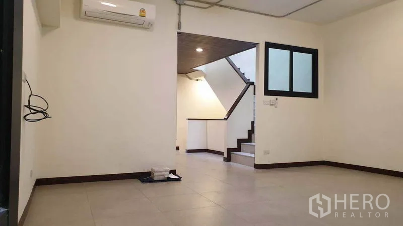 Townhouse for rent or sale in Khlong Toei, Bangkok - Second living room with air conditioning beside the staircase landing.