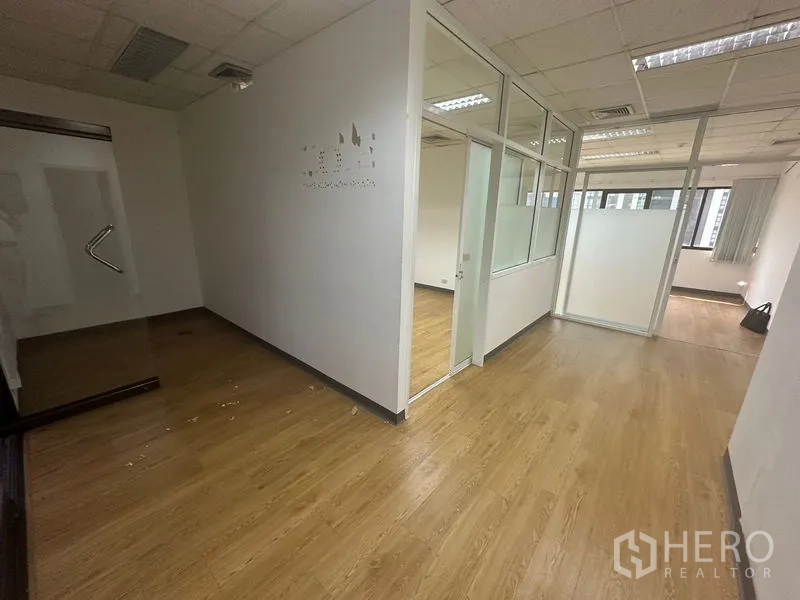 Office Space for rent in Watthana, Bangkok - Reception or entry area with glass partitions and wood floors in a clean office.