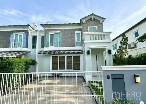 บ้าน ให้เช่าหรือขายในPrawet, Bangkok - มุมมองด้านหน้าบ้านเดี่ยวสองชั้นสไตล์โมเดิร์น มีรั้ว ที่จอดรถ และสนามหญ้าเล็ก พร้อมระเบียงชั้นบนในเขตประเวศ