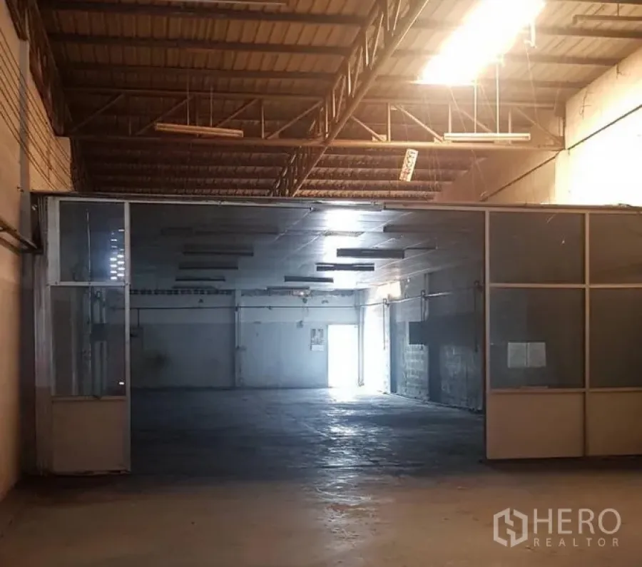 Warehouse for rent in Khlong Luang, Pathum Thani - Spacious warehouse floor with high steel-truss ceiling, concrete floor and glass-partitioned room.