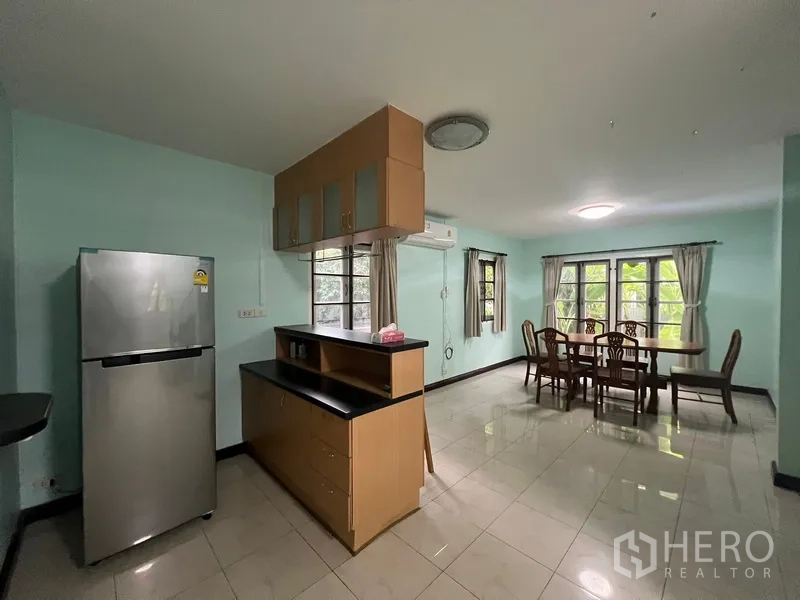 Detached House for rent in Bang Na, Bangkok - Open dining area next to the kitchen with large windows and air conditioner