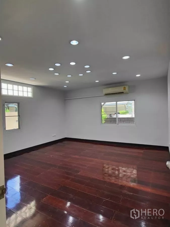 Detached House for rent or sale in Mueang Nonthaburi, Nonthaburi - Extra-large multipurpose room with recessed ceiling lights and dark wood floor.