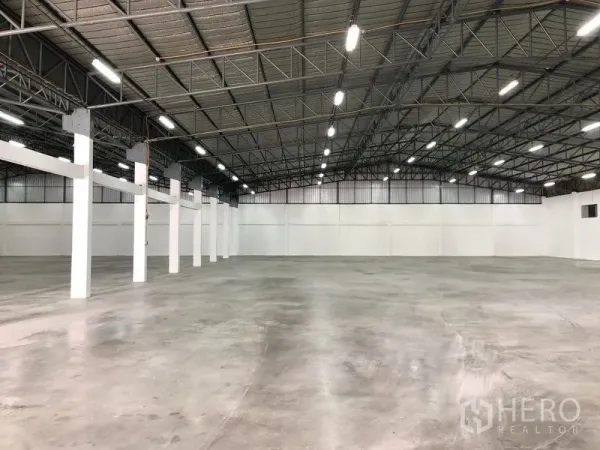 货栈 出租在Pak Kret, Nonthaburi - 仓库内部开阔，钢桁架高屋顶，LED照明充足，地面为抛光混凝土。