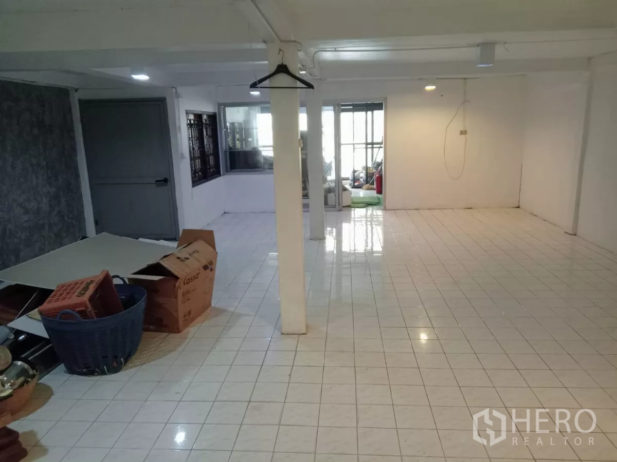 Detached House for rent in Phaya Thai, Bangkok - Large white-tiled multipurpose room with columns.