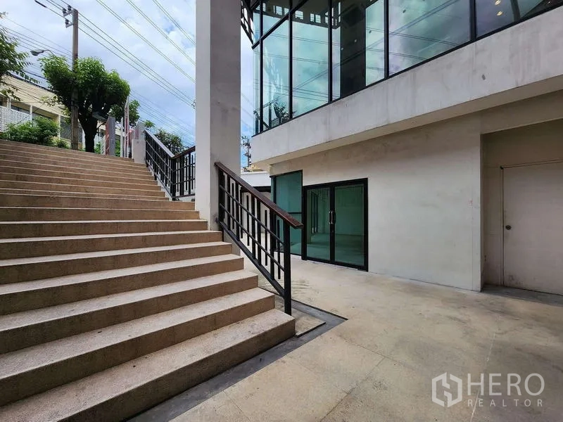 Retail Space for rent in Sathon, Bangkok - Exterior staircase leading to glass-wrapped retail entrance within contemporary building.