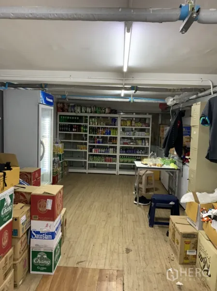 Retail Space for rent in Sathon, Bangkok - Stocked storeroom featuring beverage fridge, metal shelves and boxes on wood-look flooring.