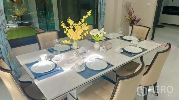 Detached House for rent or sale in Bang Kapi, Bangkok - Elegant dining table set for six with marble top, place settings and floral centerpiece.