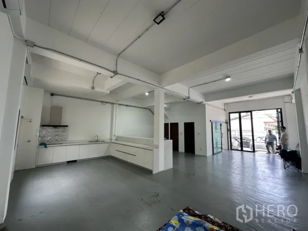 Home Office for rent or sale in Bang Na, Bangkok - Open workspace with kitchenette and wide glass entrance doors.