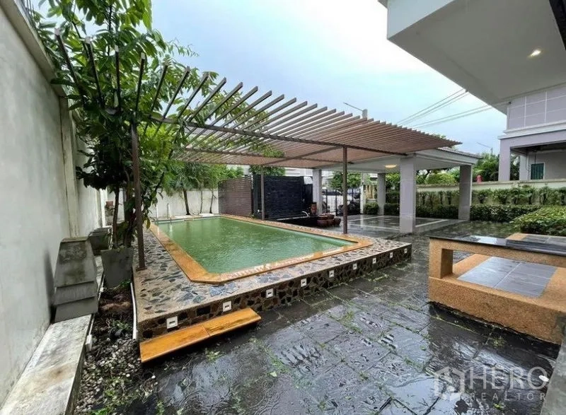 Detached House for sale in Bang Phli, Samut Prakan - Private swimming pool with pergola, slate terrace and plants in a walled garden.