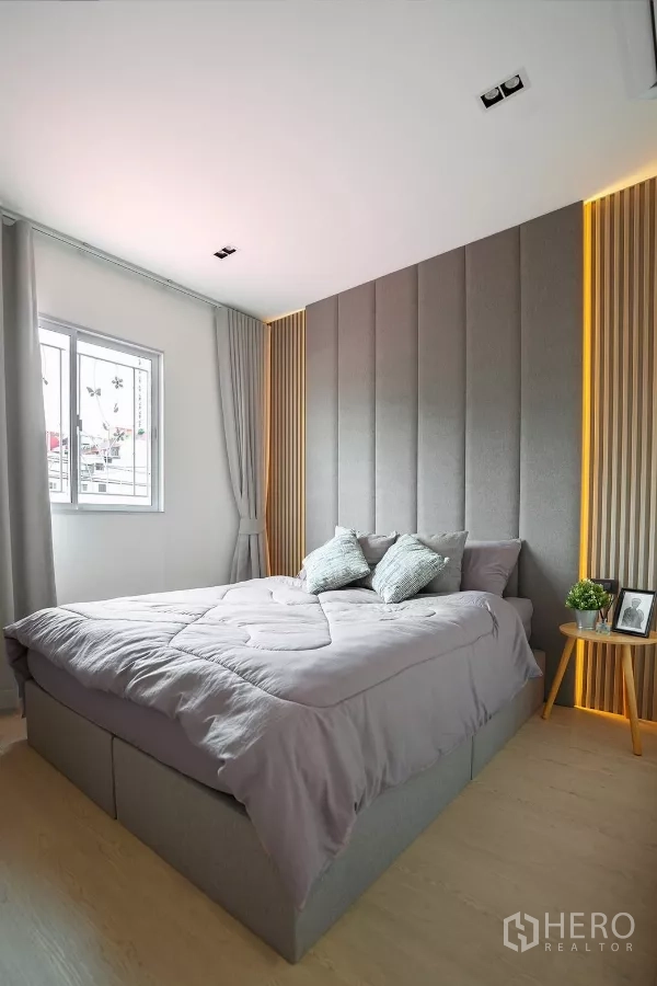 Detached House for rent in Huai Khwang, Bangkok - Bedroom with padded headboard, warm strip lighting and window.