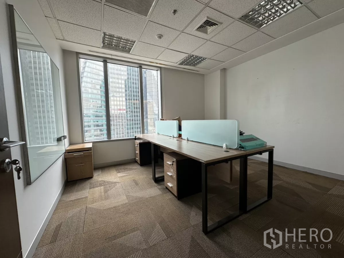 Office Space for rent in Watthana, Bangkok - Private office with twin desks, a whiteboard and views of high-rise towers.