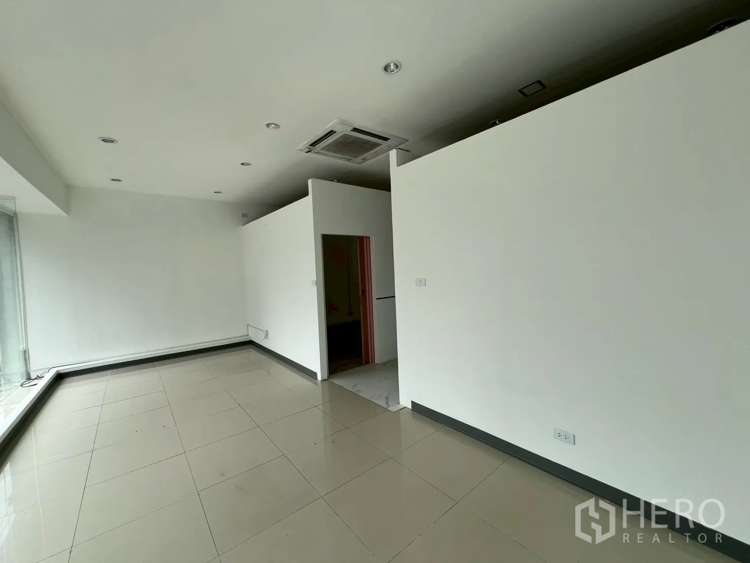 Retail Space for rent in Watthana, Bangkok - Spacious back area with partitions and a cassette air conditioner.