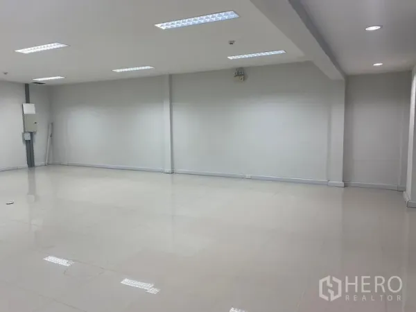 Office Space for rent in Bang Na, Bangkok - Spacious white office floor with strip lighting and polished tiles.