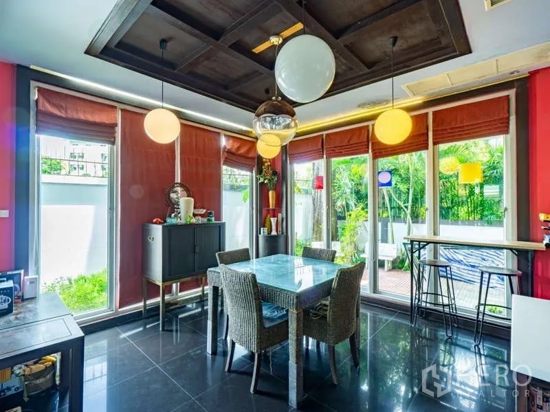Detached House for sale in Suan Luang, Bangkok - Bright dining corner with round pendant lights and sliding doors to the patio.