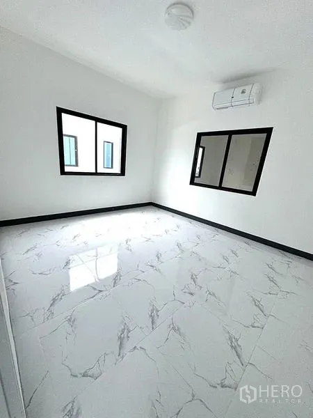 Warehouse for rent in Khlong Luang, Pathum Thani - Bright bedroom or office with marble-look tiles, windows and wall air conditioner.