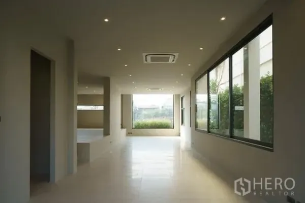Home Office for sale in Wang Thonglang, Bangkok - Bright open-plan ground floor with large windows, recessed lighting and garden outlook.