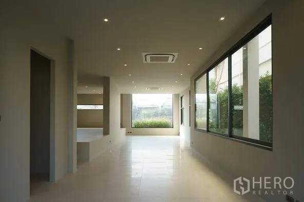 Home Office for sale in Wang Thonglang, Bangkok - Bright open-plan ground floor with large windows, recessed lighting and garden outlook.