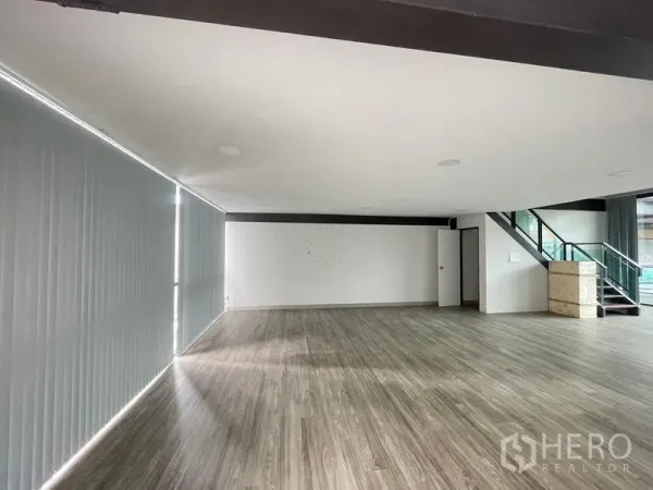Office Space for rent in Bang Na, Bangkok - Large office area showing staircase to mezzanine, white walls, private door and expansive floors.