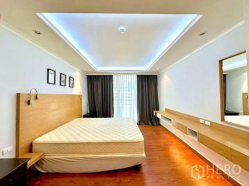 Condominium for rent - Spacious master bedroom with tray ceiling lighting, large window and built-in console.